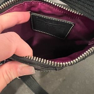 Medium Coach cross body purse, black out beautiful purple inside.